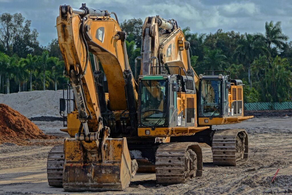 Caterpillar and John Deere Heavy Construction Equipment in a Davie Field under a cloudy sky. A drive-by opportunity I tu