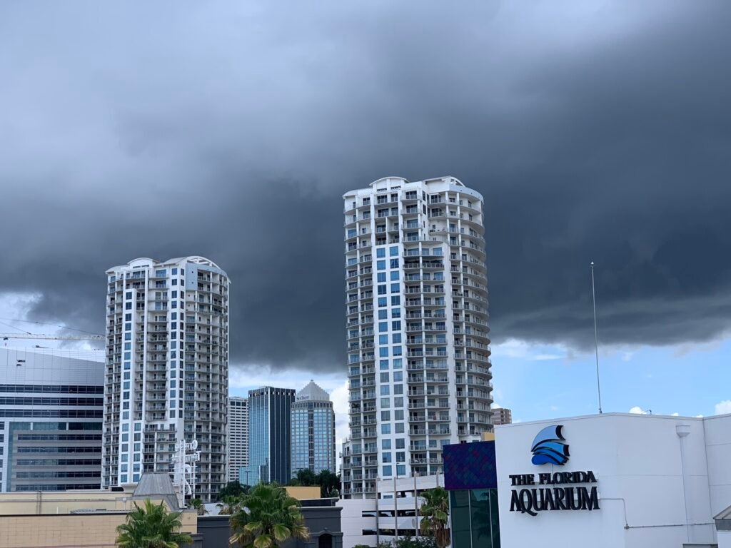 An approaching dark storm cloud covers the sky above an aquarium in Tampa, Florida, USA.