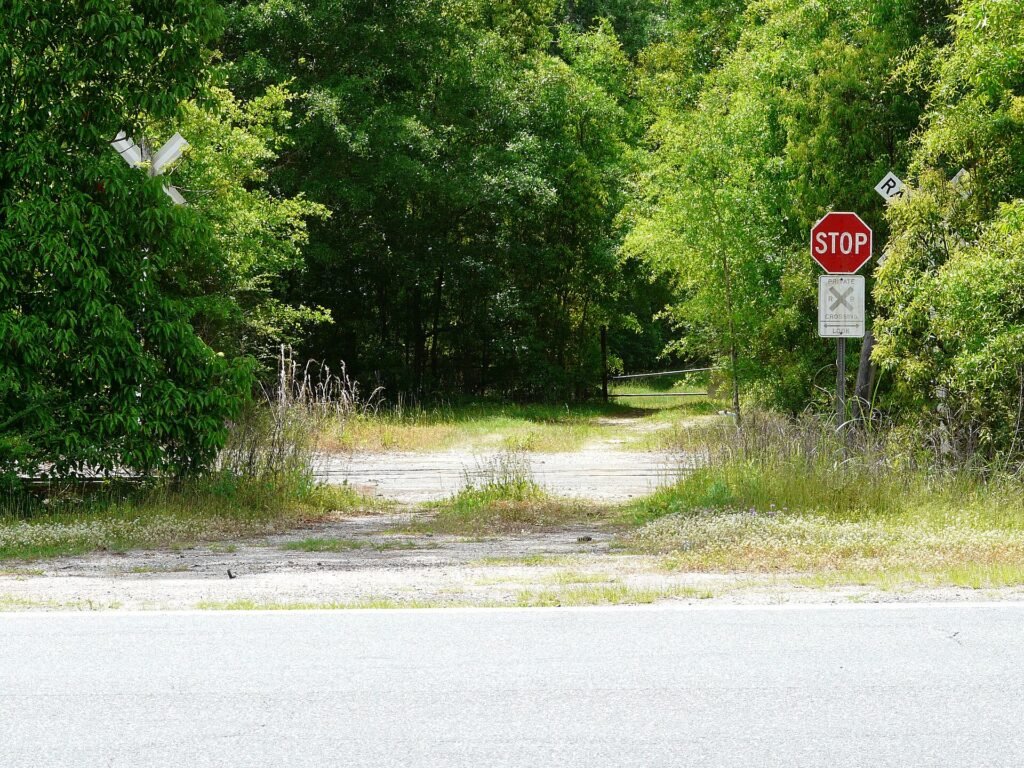 The Tallahassee Subdivision of the Florida Gulf and Atlantic Railroad crosses a driveway on the south side of U.S. Route