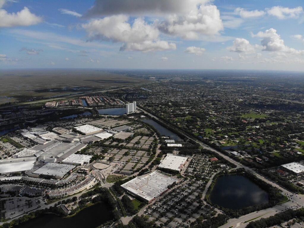 An aerial shot of the Sawgrass Mills mall (left) and subdivisions in Sunrise, Florida (top), and Plantation, Florida (ri