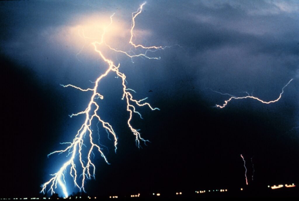 Multiple cloud-to-ground and cloud-to-cloud lightning strokes during night-time. Observed during night-time thunderstorm
